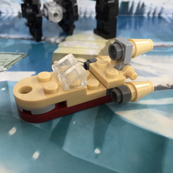 LEGO micro-scale build of Luke's landspeeder in tan with a small hole in the hood and no passengers. Right and left engines are identical.