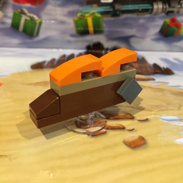 LEGO microscale model of  Jabba's sail barge. The build is mostly brown with orange curved slopes for the sails.