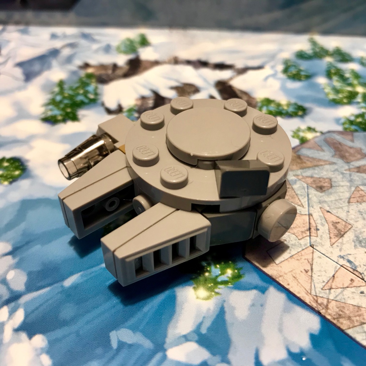 LEGO microscale model of  the Millennium Falcon. This version uses a cheese slope to form a square radar dish, indicating that this is the Force Awakens era Falcon.