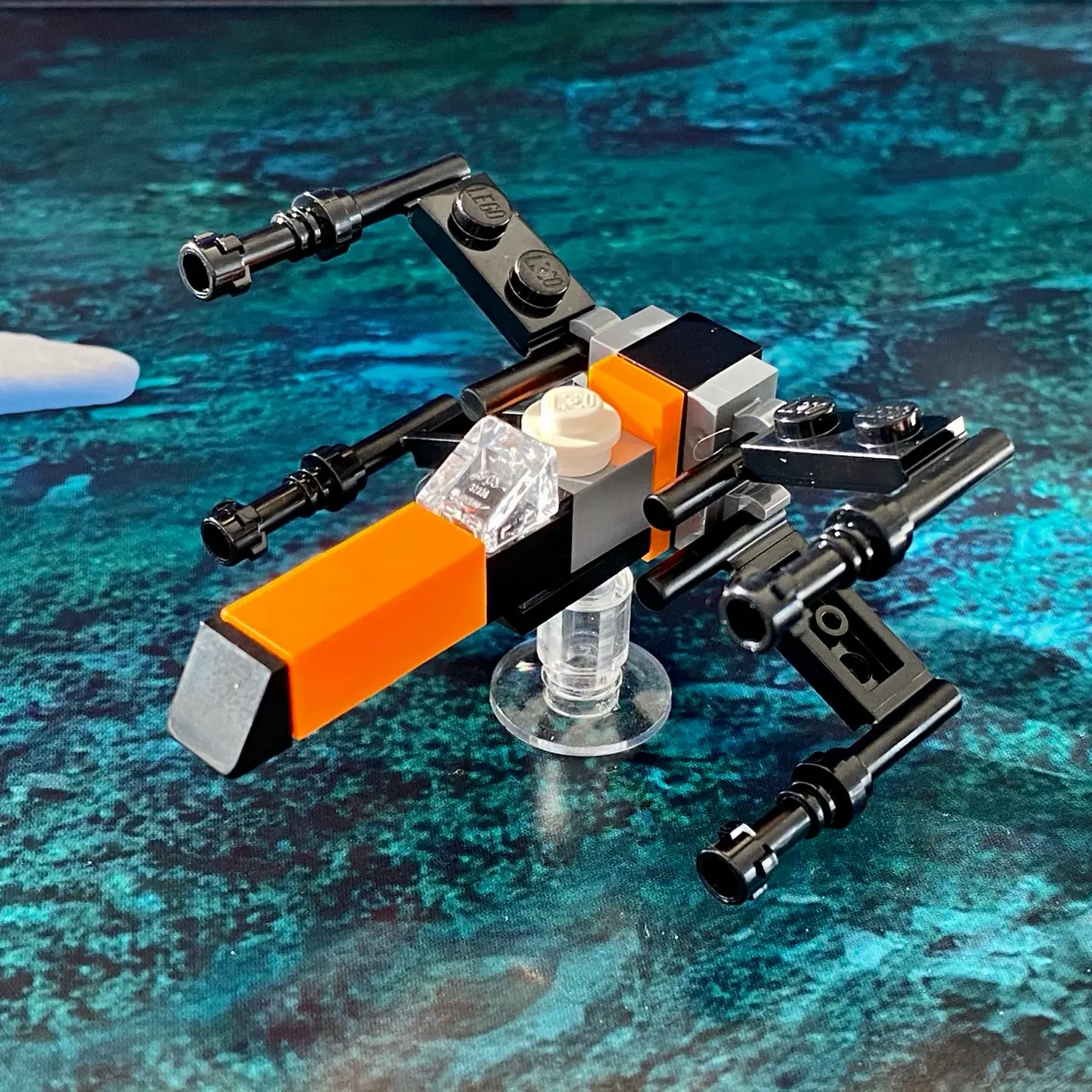 LEGO microscale build of Poe Dameron's X-Wing Starfighter from the 2019 advent calendar built in a black and orange color scheme