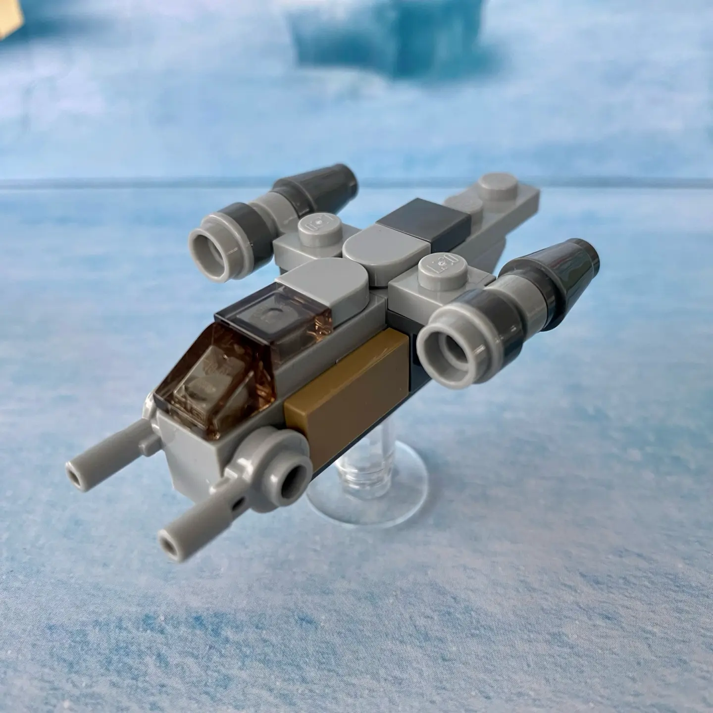 LEGO micro-scale build of the Razor Crest, a light gray spaceship with two engine clusters. This version is 7 studs long, which gives it nice proportions. Its engines are spaced wider than the 2020 version