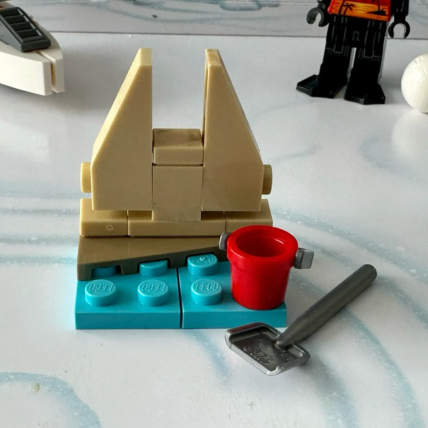 LEGO micro-scale model of a sand castle in shades of tan that has the two-towered shape of Darth Vader's castle on Mustafar.