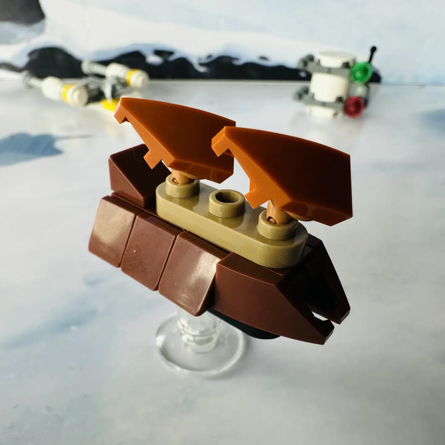 LEGO micro-scale model of Jabba's sail barge in brown with tan highlights and two dark orange sails.