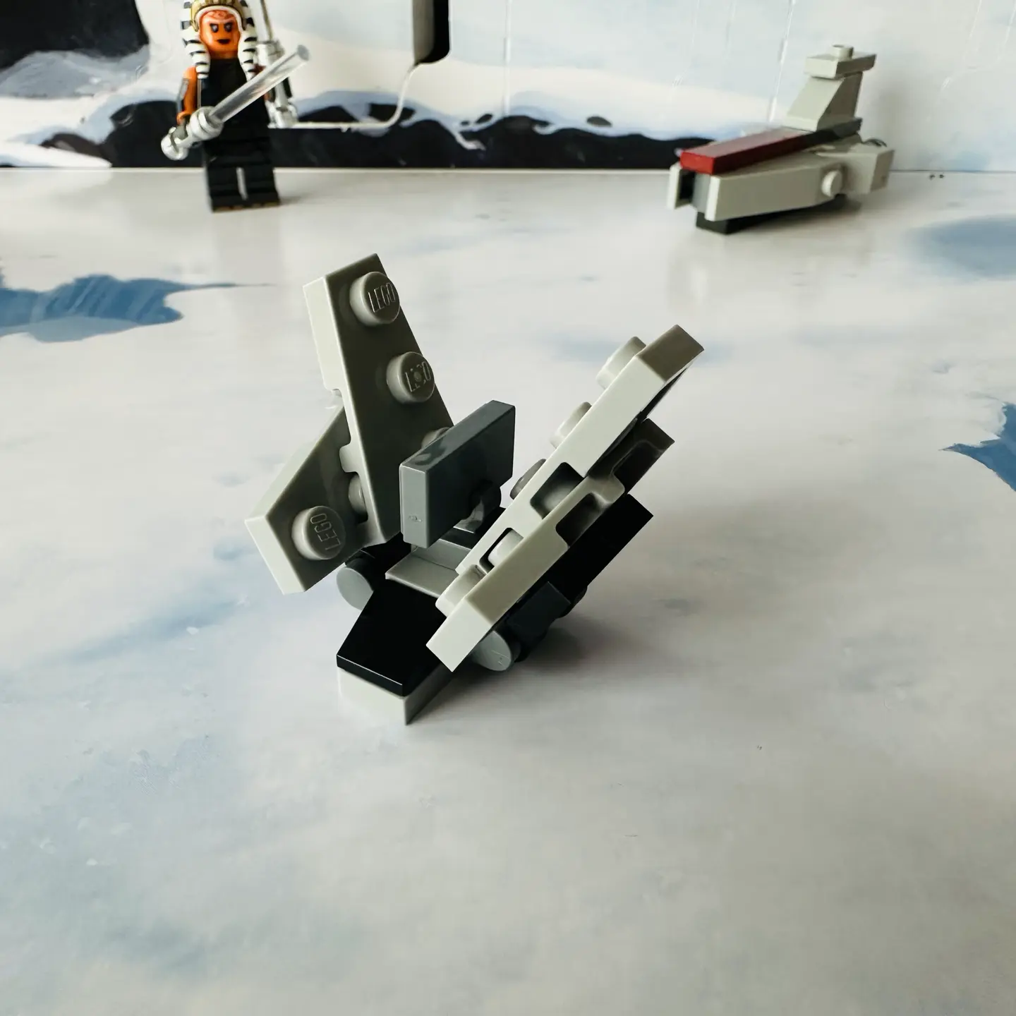 LEGO micro-scale model of a a light gray tri-wing imperial shuttle with a black windscreen with its side wings folded up into landing position