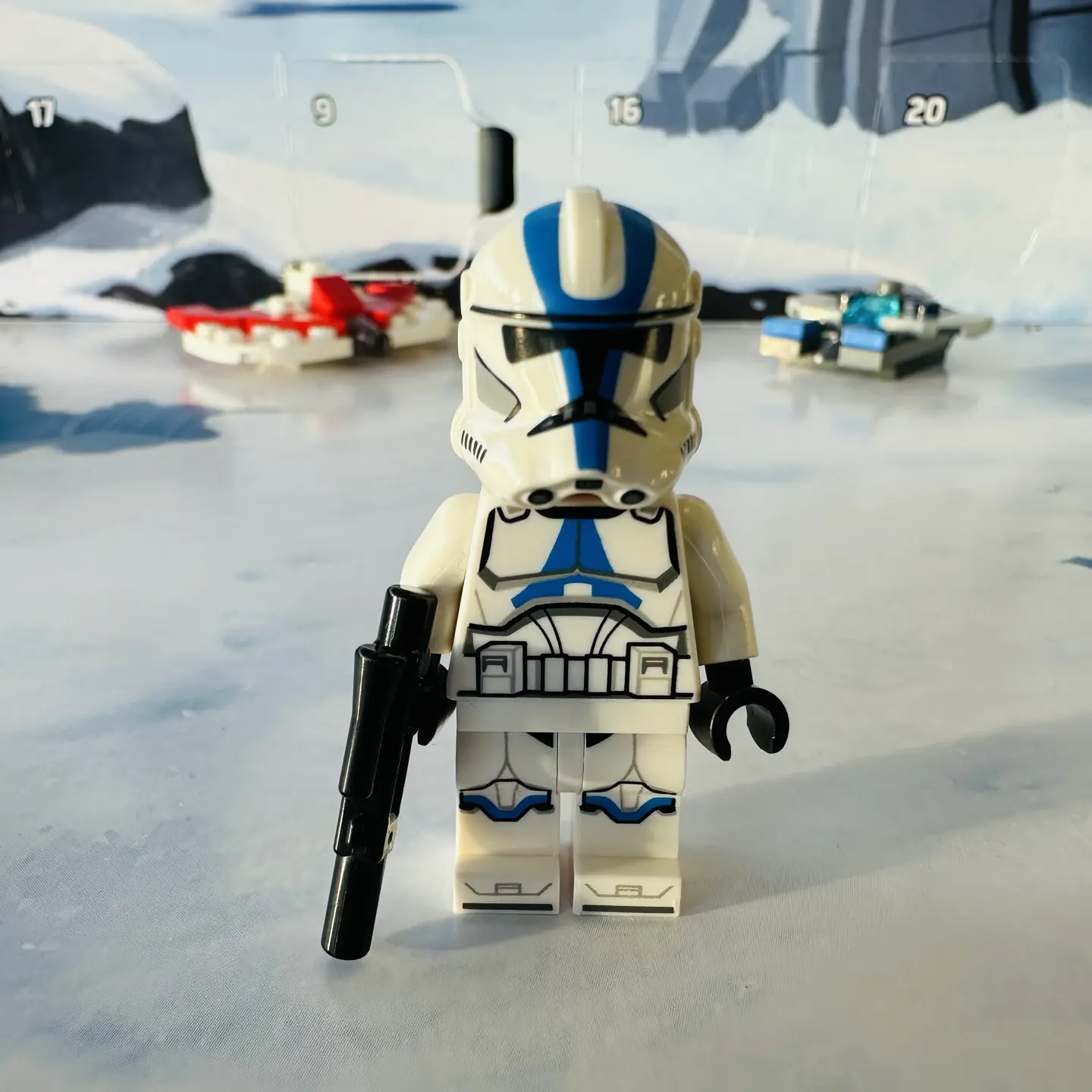 LEGO minifigure of a Republic Clone Trooper with blue highlights on their armor and holding a blaster