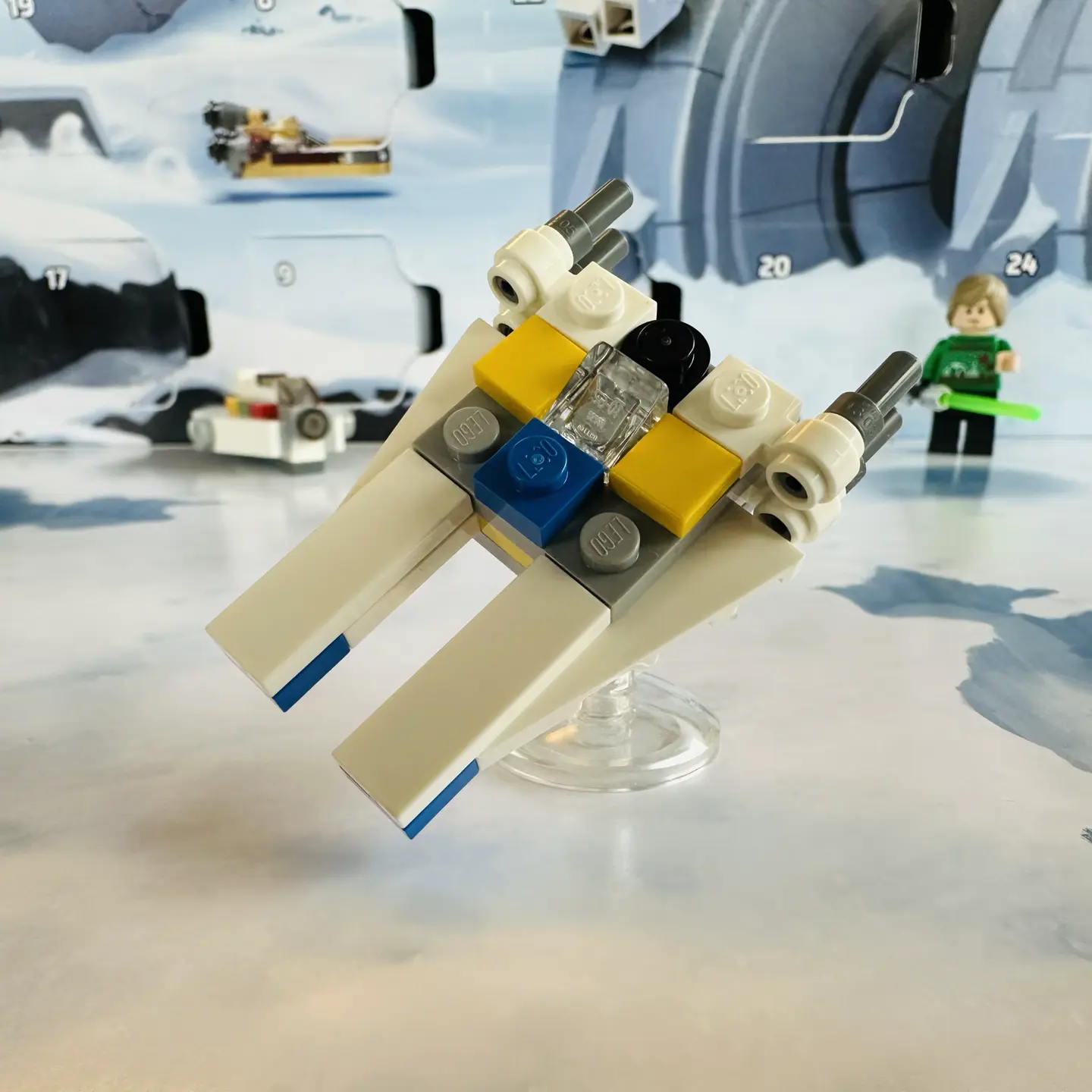 LEGO micro-scale build of a U-Wing Starfighter in white with quad engines and yellow and blue highlights