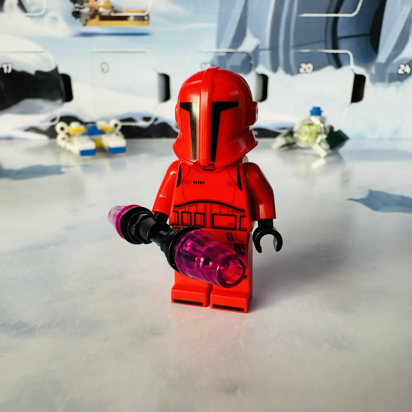 LEGO minifig of a Praetorian Guard, which looks like a red stormtrooper holding a double-ended energy staff