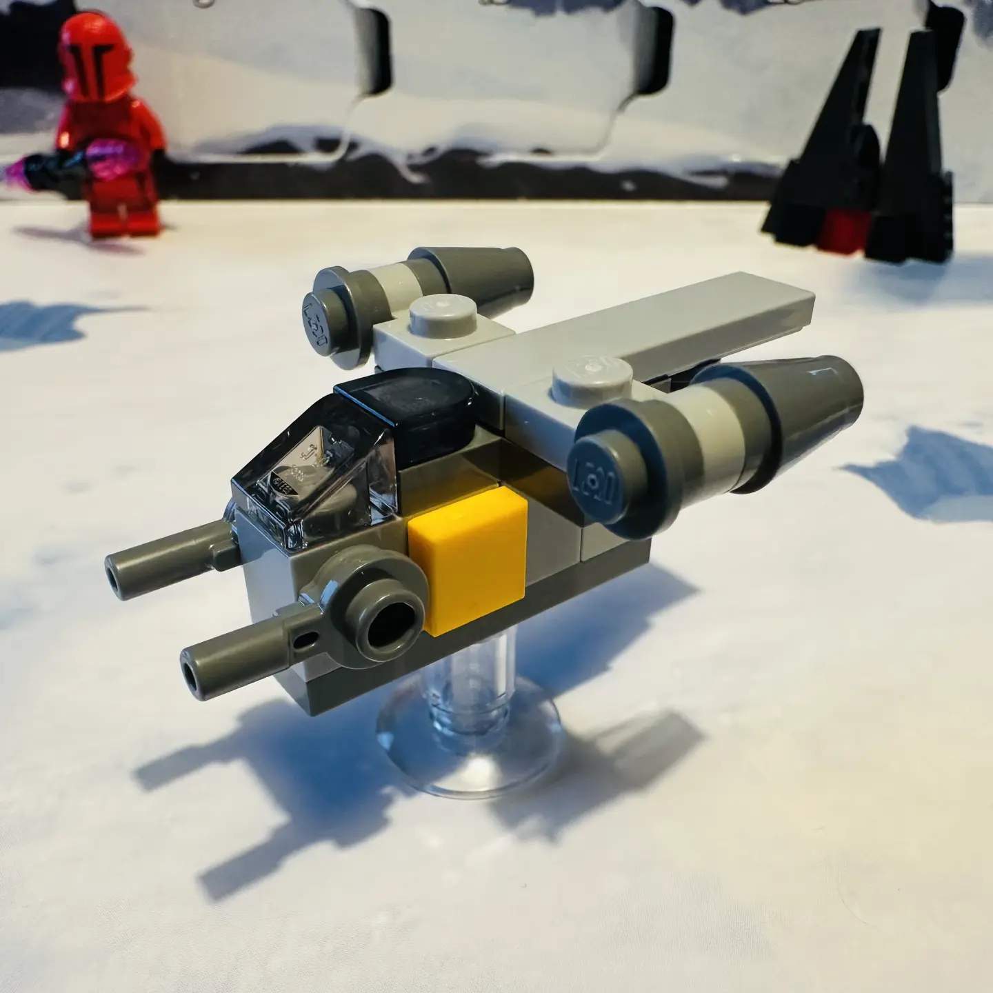 LEGO micro-scale build of the Razor Crest, a light gray spaceship with two engine clusters. This version is only 6 studs long, making it chunkier than earlier versions.