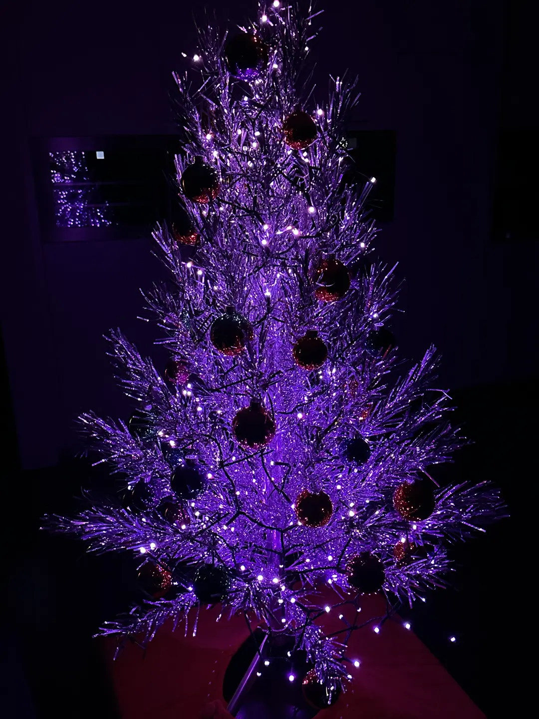 Aluminum Christmas tree decorated only with glass balls and purple string lights (Philips Hue Pandemonium scene).