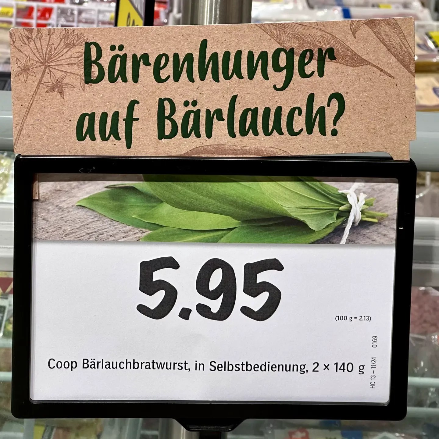 Supermarket sign seen in Switzerland advertising bärlauch-flavored bratwurst. The sign reads in German "Bärenhunger auf Bärlauch?"