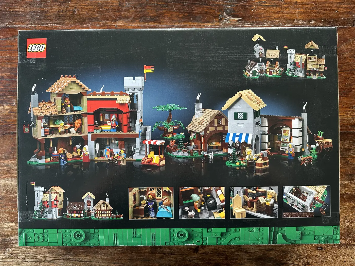 Box rear for LEGO set 10332: Medieval Town Square. Box art depicts the dollhouse-style open back sides of two different clusters of medieval buildings. Several closeup photos of the interiors are included.