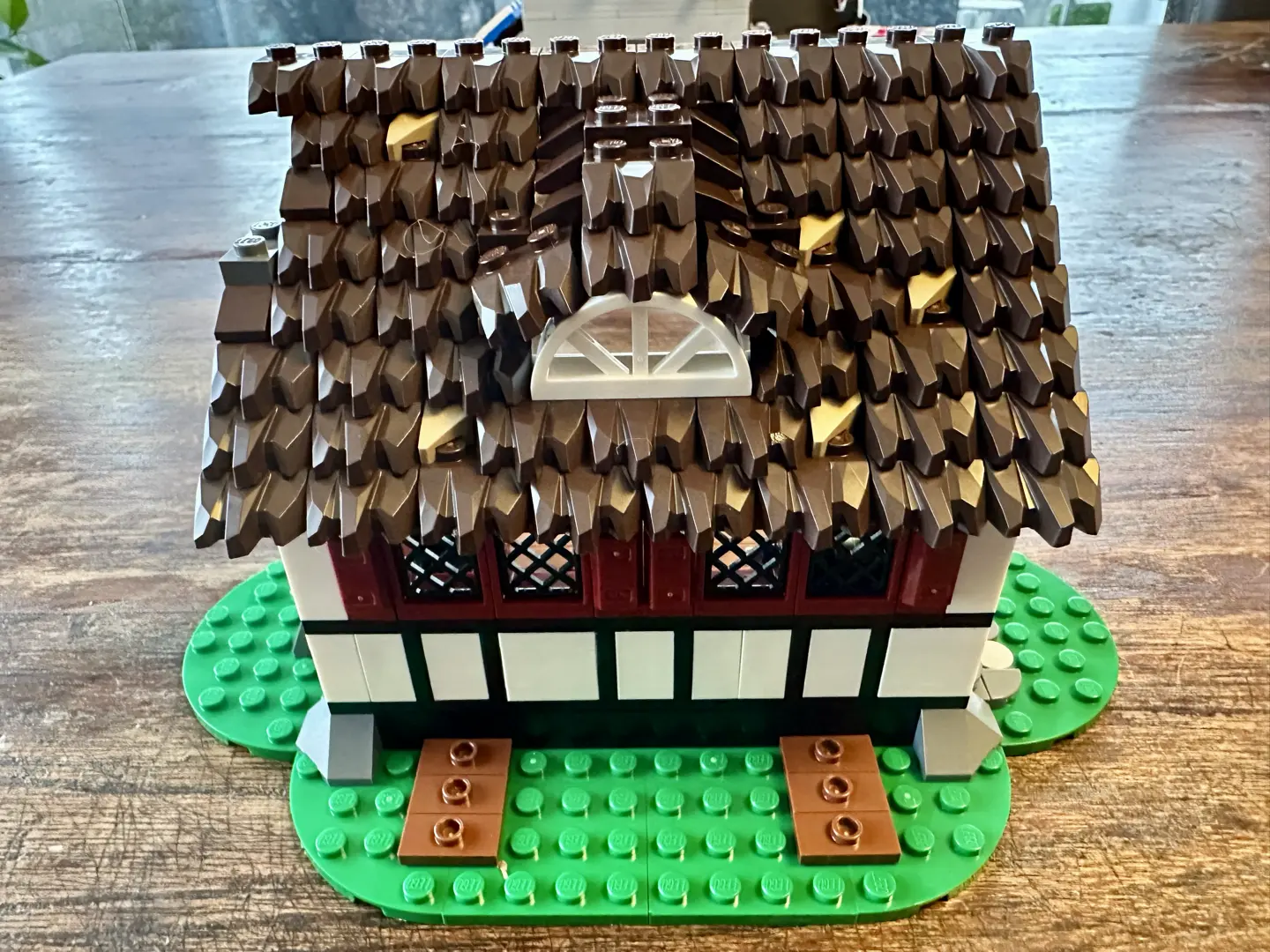 LEGO darkly thatched farmhouse roof with an inset white half-circle window.