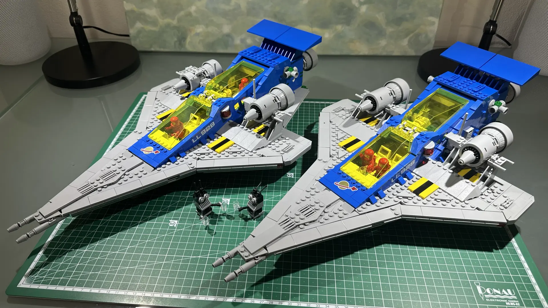 Two copies of LEGO set 10497 Galaxy Explorer side-by-side on a cutting mat