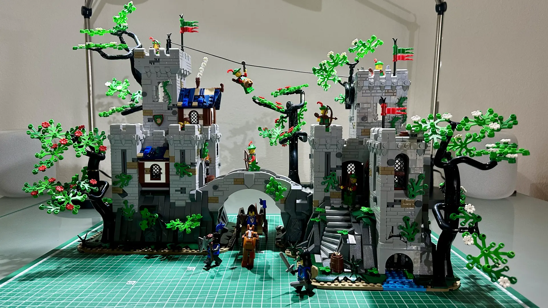 LEGO set 910043 built on my desk. It consists of two gray stone castles joined by an arched bridge.