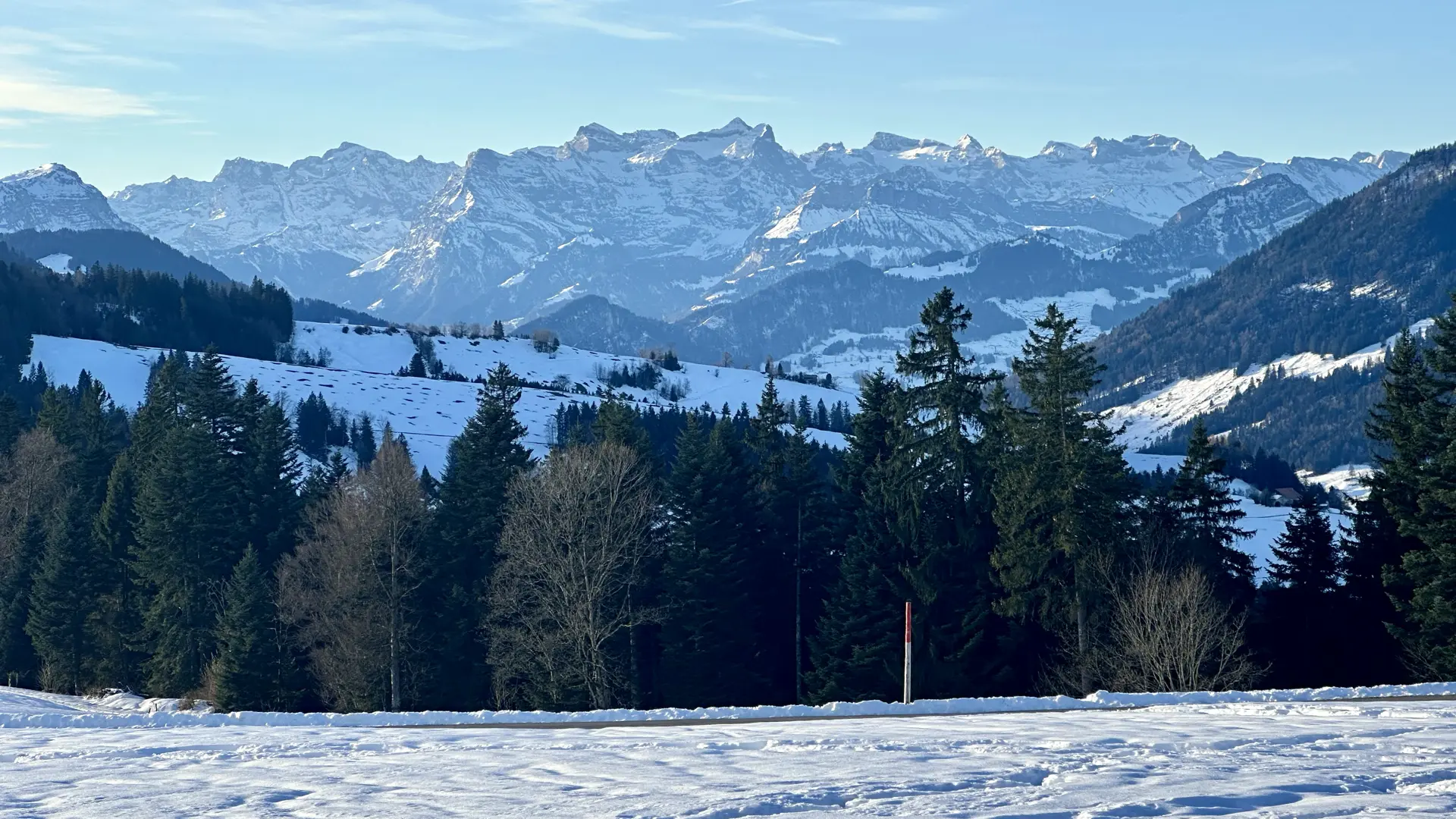 Zoomed photo of distant snow-covered mountains (Swiss Alps).